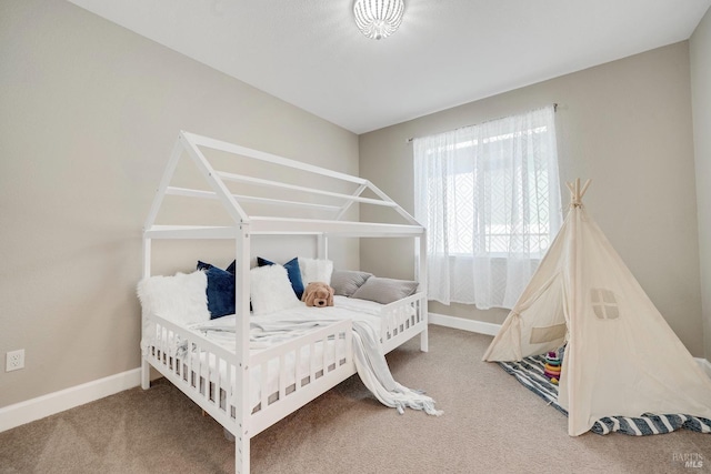bedroom featuring carpet and baseboards
