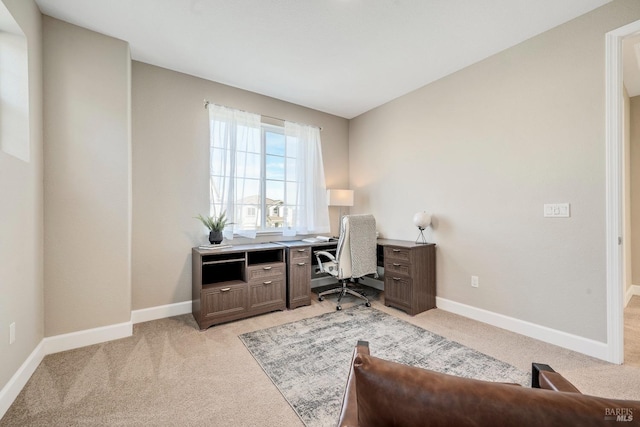 office space with light carpet and baseboards