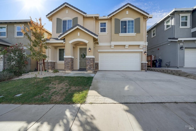 view of front of home featuring a tiled roof, stucco siding, an attached garage, driveway, and stone siding