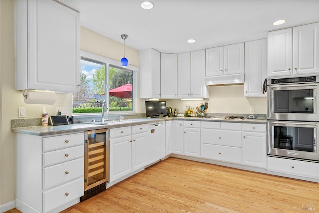 195 Mountain Vista Pl, Santa Rosa, CA 95409 - kitchen with wine cooler, stainless steel appliances, under cabinet range hood, white cabinetry, and recessed lighting