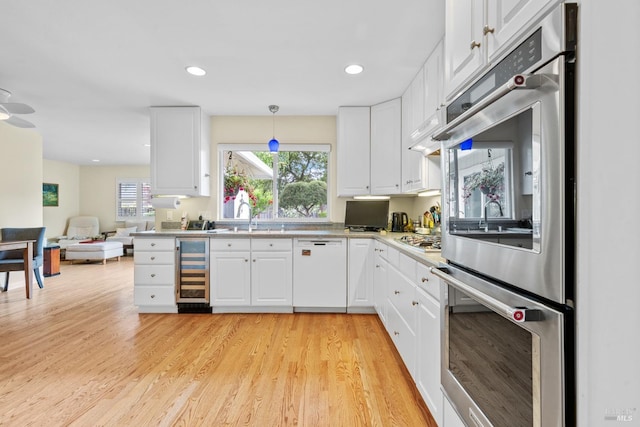 195 Mountain Vista Pl, Santa Rosa, CA 95409 - kitchen with appliances with stainless steel finishes, wine cooler, light countertops, white cabinets, and recessed lighting