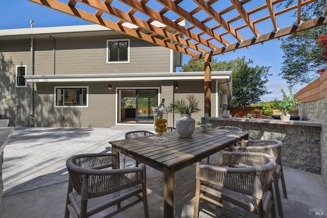 view of patio featuring outdoor dining area and a pergola
