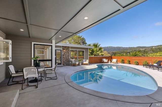 view of swimming pool featuring a patio, fence, and a fenced in pool