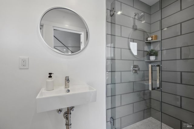 full bath with a stall shower and a sink