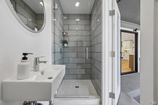 bathroom featuring a sink and tiled shower