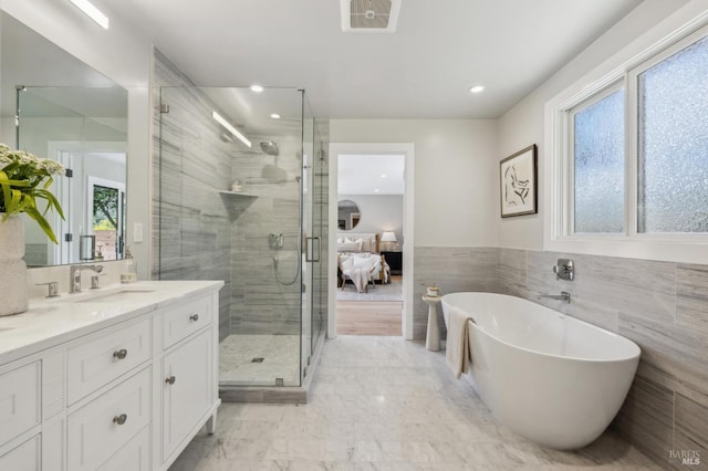 bathroom featuring a shower stall, visible vents, recessed lighting, a freestanding tub, and vanity