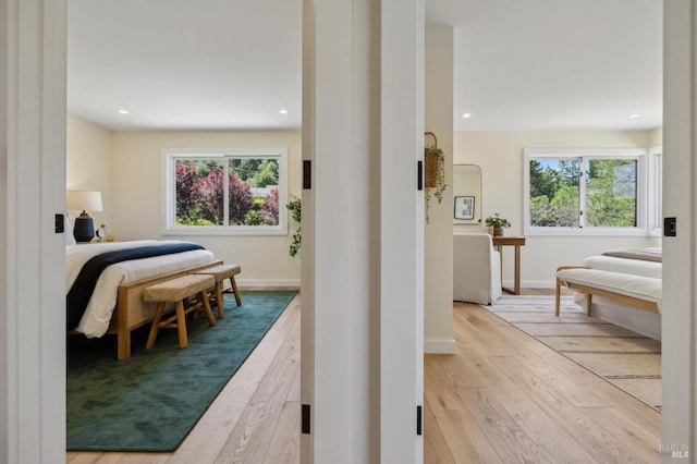 bedroom featuring wood finished floors, recessed lighting, and multiple windows