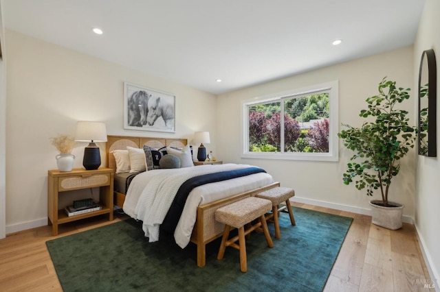 bedroom featuring light wood-type flooring, recessed lighting, and baseboards