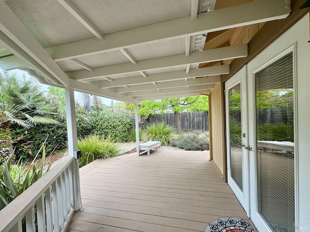 wooden terrace with fence and french doors