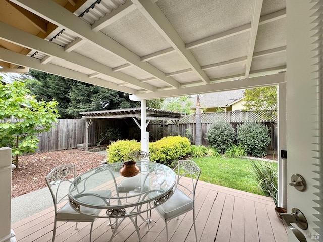 wooden terrace with a lawn, a fenced backyard, and outdoor dining area
