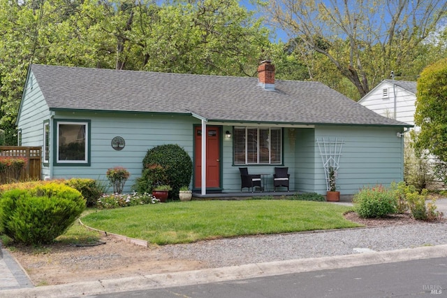 single story home with a shingled roof, a porch, a front lawn, and a chimney