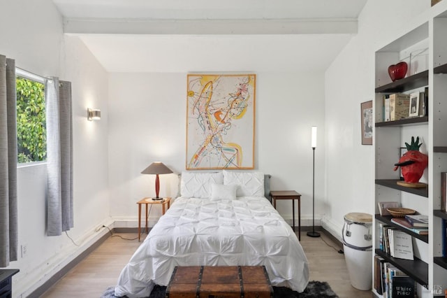 bedroom featuring baseboards and wood finished floors