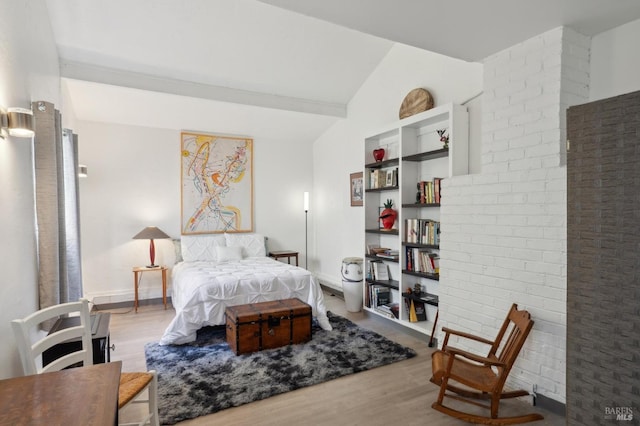 bedroom featuring vaulted ceiling, wood finished floors, and baseboards