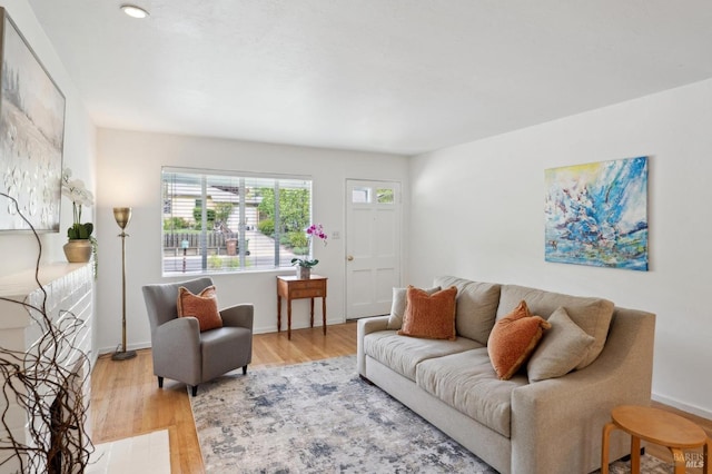living room with baseboards and light wood-style floors