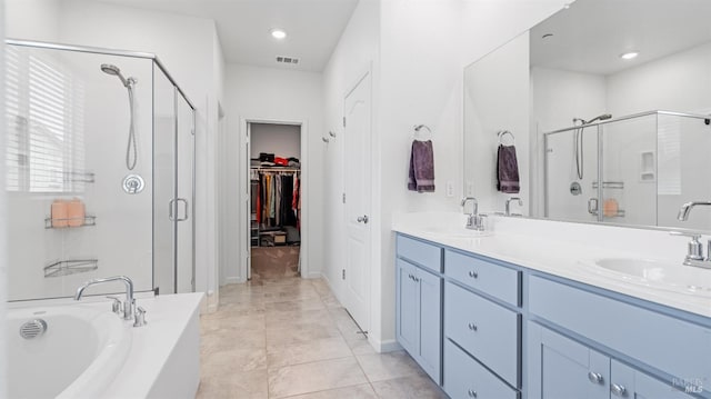 2350 White Dr, Fairfield, CA 94533 - bathroom featuring a stall shower, a bath, double vanity, a walk in closet, and recessed lighting