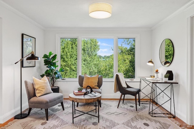 sitting room with baseboards, wood finished floors, and ornamental molding
