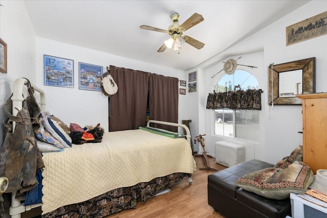 bedroom featuring ceiling fan, vaulted ceiling, and wood finished floors