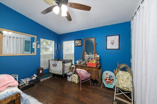 bedroom with lofted ceiling, a ceiling fan, and wood finished floors