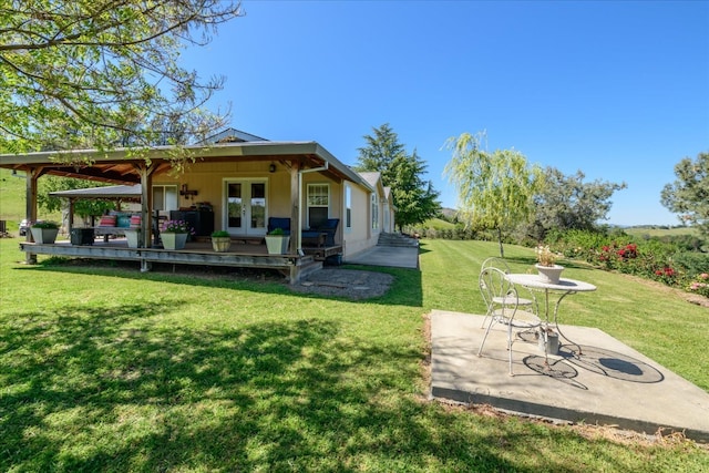 view of yard with a patio area and french doors