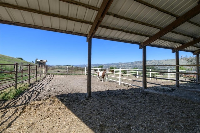 view of yard with an exterior structure, a rural view, an outdoor structure, and a mountain view