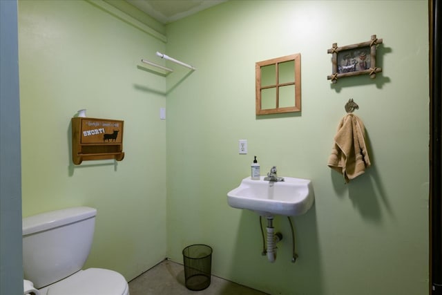 half bath with toilet and a sink