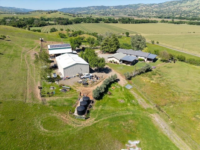 drone / aerial view featuring a mountain view and a rural view