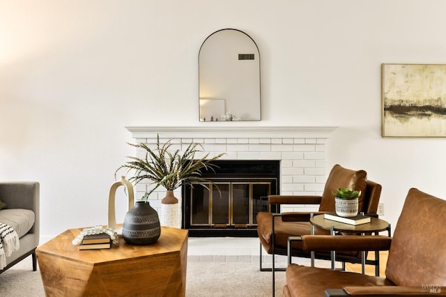 living area featuring visible vents and a fireplace