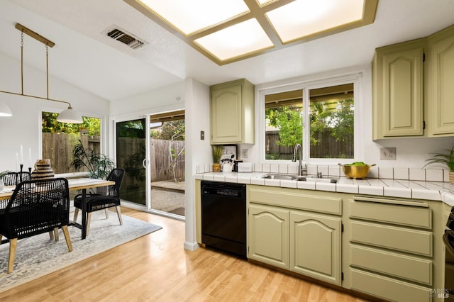 kitchen featuring light wood-style floors, black dishwasher, visible vents, and a sink