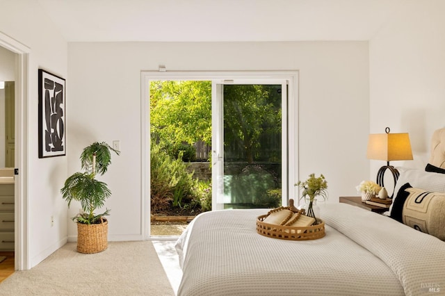 carpeted bedroom with baseboards and access to exterior