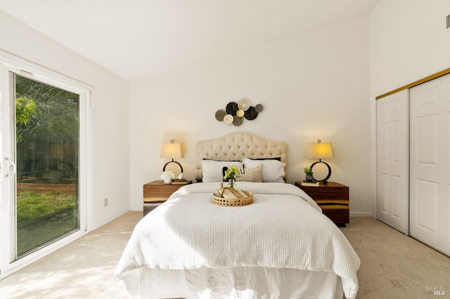 bedroom featuring light colored carpet, baseboards, access to exterior, and a closet