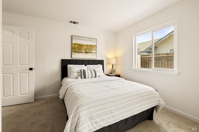 bedroom featuring visible vents, carpet flooring, and baseboards