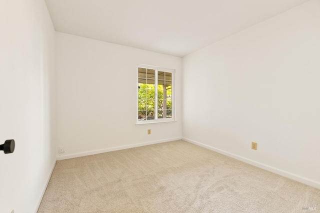 empty room with baseboards and carpet flooring