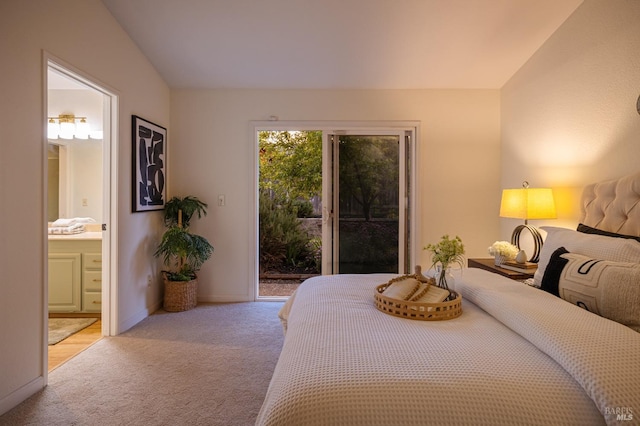 bedroom featuring light carpet, access to exterior, vaulted ceiling, baseboards, and ensuite bath