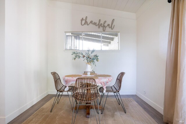 dining area featuring baseboards and wood finished floors