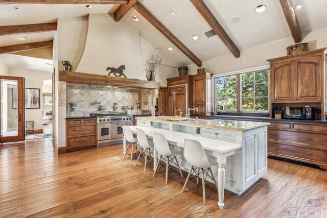 1571 Silver Trl, Napa, CA 94558 - kitchen featuring tasteful backsplash, double oven range, visible vents, light wood-style floors, and beamed ceiling