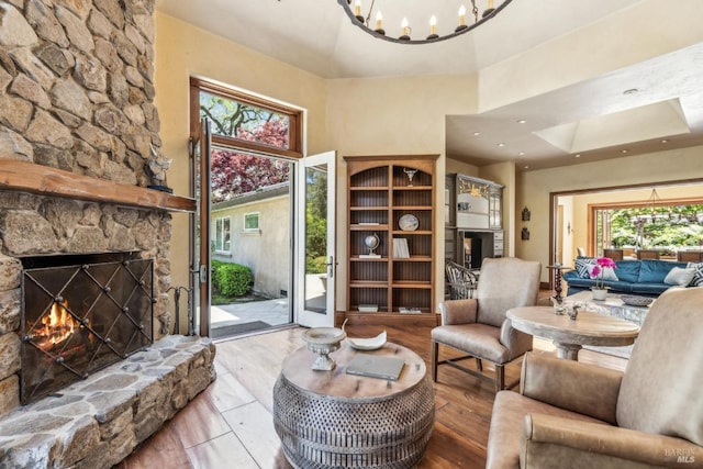 1571 Silver Trl, Napa, CA 94558 - living room featuring wood finished floors, a stone fireplace, a skylight, a towering ceiling, and a notable chandelier