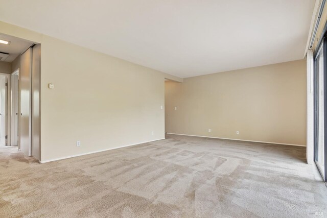 carpeted spare room with baseboards