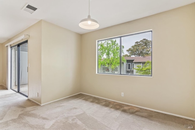 carpeted empty room with baseboards and visible vents