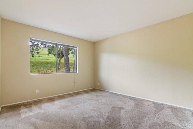 unfurnished room with baseboards and carpet