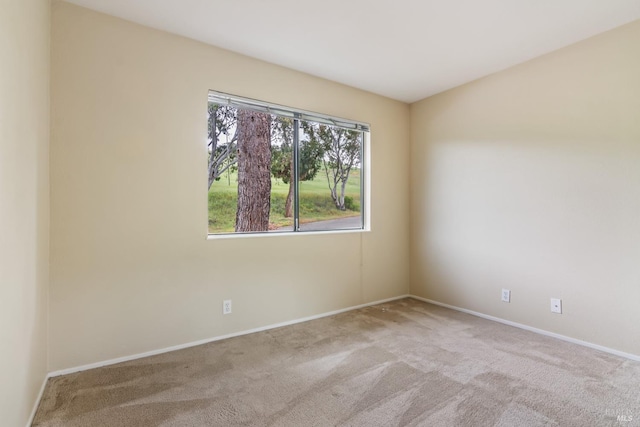 unfurnished room with carpet flooring and baseboards