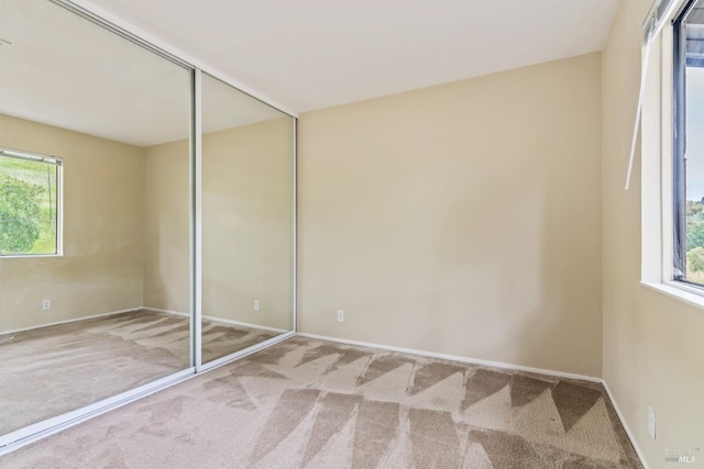 unfurnished bedroom with baseboards and carpet