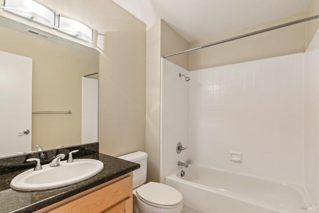 full bath featuring shower / bathing tub combination, visible vents, toilet, and vanity