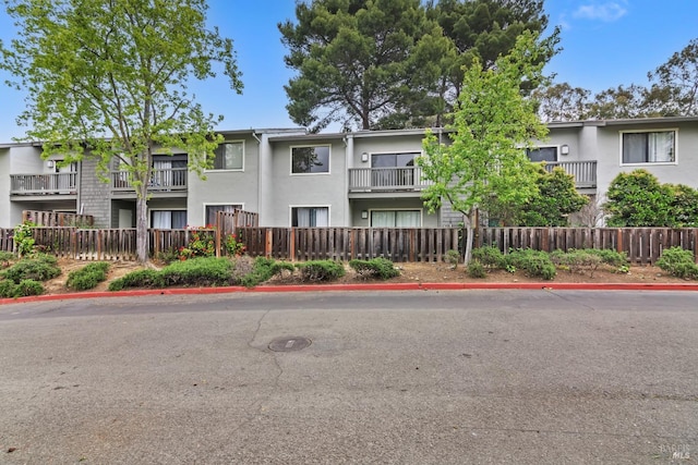 view of property with fence
