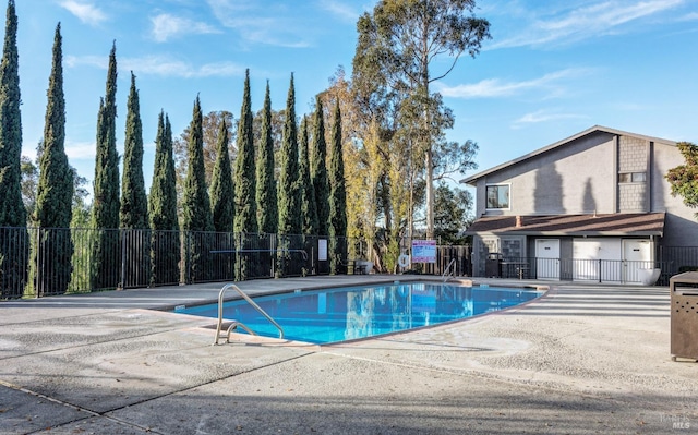 pool featuring fence and a patio