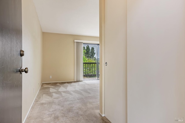 corridor featuring carpet flooring and baseboards
