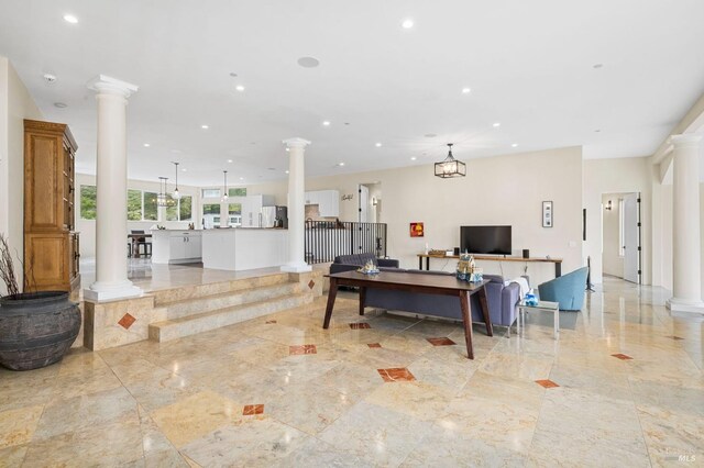 living area with ornate columns, light marble finish flooring, and recessed lighting