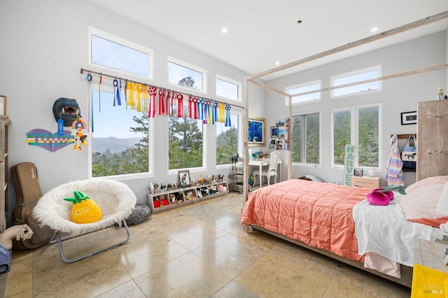 bedroom featuring recessed lighting and a towering ceiling