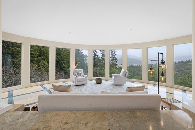 sunroom / solarium with plenty of natural light and a mountain view