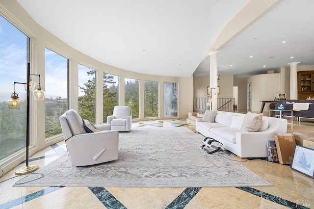 living room featuring ornate columns, plenty of natural light, inlaid floor details, and recessed lighting