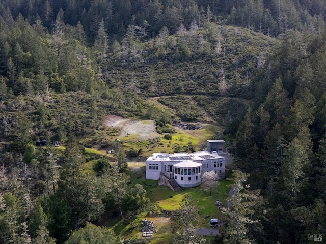 aerial view of property's location with a forest